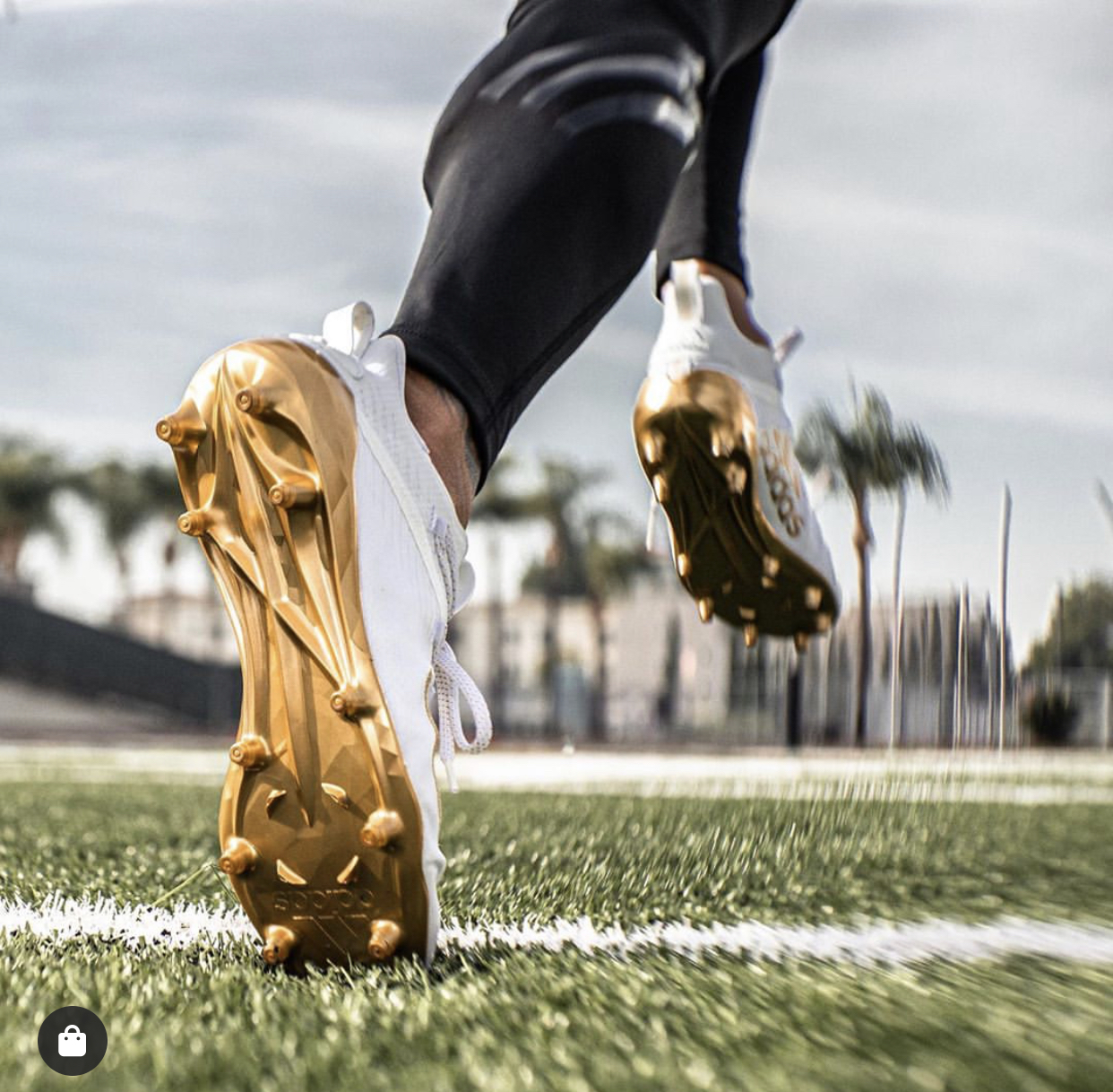 Gold cleats mid-stride on a training field